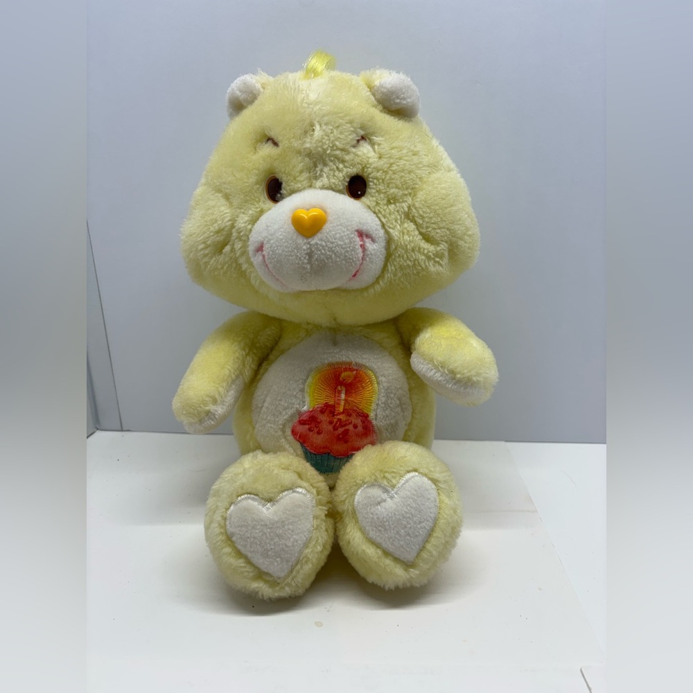 Vintage yellow Birthday Bear Care Bear plush stuffed animal.